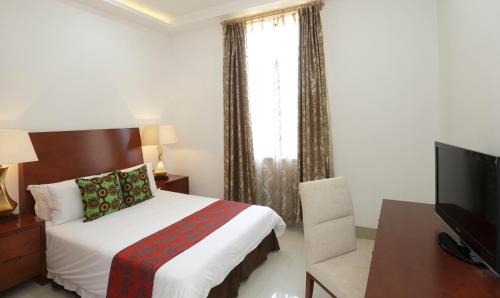 Postel nebo postele na pokoji v ubytování President Hotel at Umodzi Park