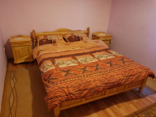 a bedroom with a bed and two night stands at Villa Vanessa Koprivki Area in Tsar Kaloyan