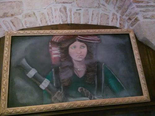 a painting of a woman in aarmor at B&B Michelina in Martina Franca