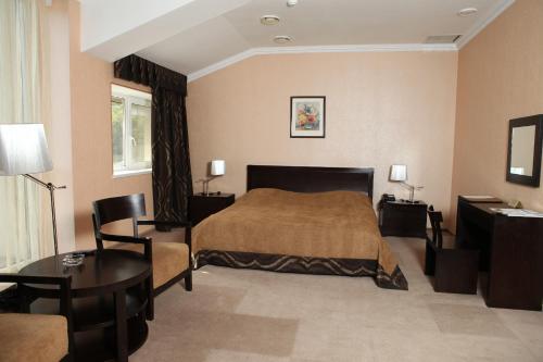 Habitación de hotel con cama y mesa en Lavina Hotel, en Dnipro