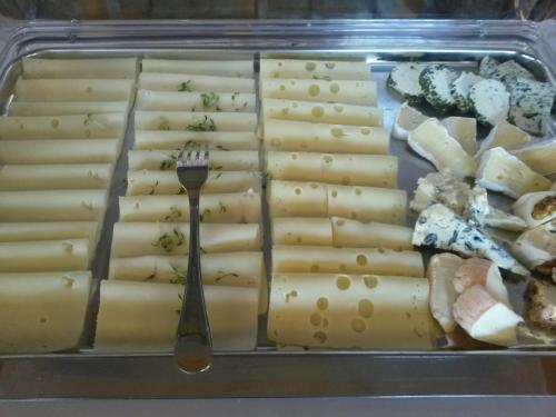 a plastic container filled with cheese and a fork at Retzerlandhof Familie Graf in Zellerndorf