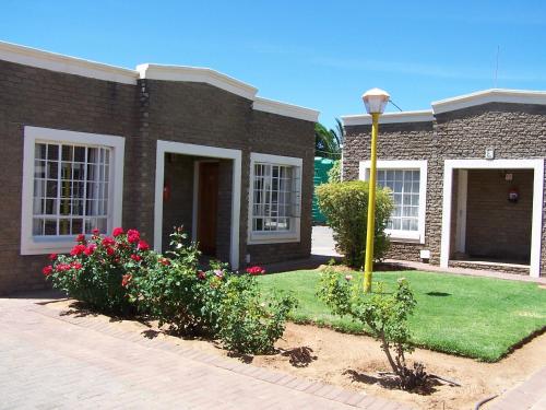 a brick house with a street light in front of it at Gables Inn in Colesberg