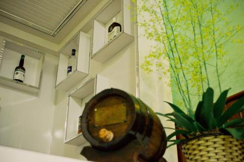 a room with a mirror and some bottles on the wall at Pampa Hotel in Vacaria