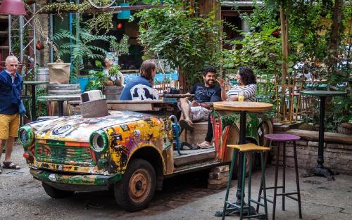a group of people sitting in the back of a truck at Three Corners Hotel Anna in Budapest