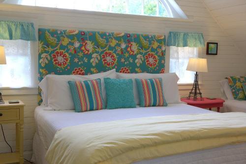 a bedroom with a large bed with a floral headboard at Long Dell Inn in Centerville