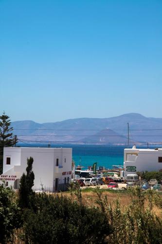 a group of buildings with the ocean in the background at Maroussa Studios in Agia Anna Naxos