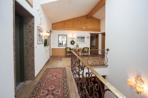 a hallway of a home with a staircase with a rug at Appartements Spullersee in Lech am Arlberg