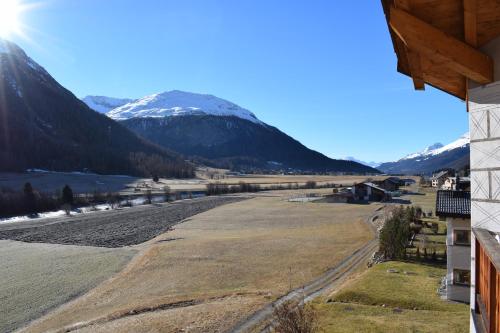a view of a river and mountains from a house at Residence Miragolf in Madulain