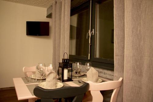a dining room table with wine glasses on it at Studio in Les Collons