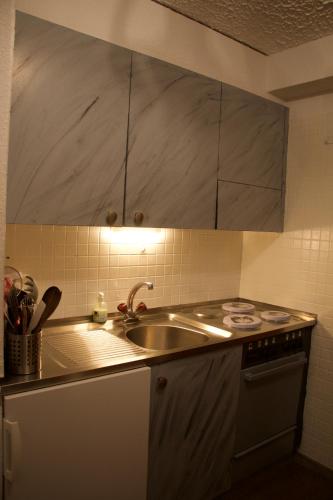 a kitchen with a sink and a stove at Studio in Les Collons