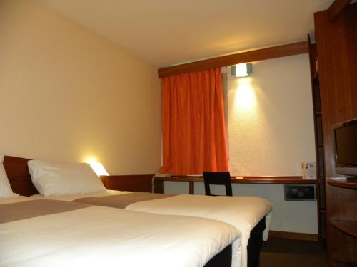 Una cama o camas en una habitación de ibis Douala