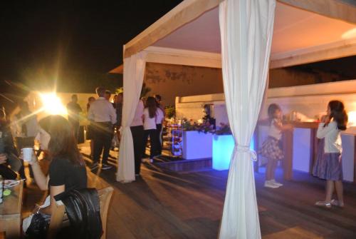 a group of people on a dance floor at a party at Marina Di Castello in Cagliari