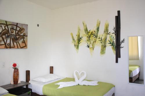 Cama o camas de una habitación en Emotion Avenida Tulum Hotel & Hostal