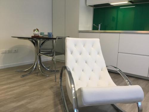 a white chair in a kitchen with a table at Wall Art Fiera in Bologna