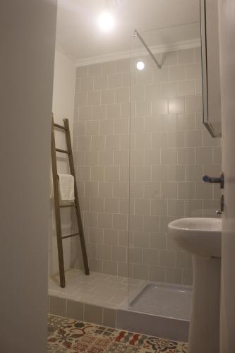 a bathroom with a shower with a sink and a ladder at Nooks Sintra three in Sintra