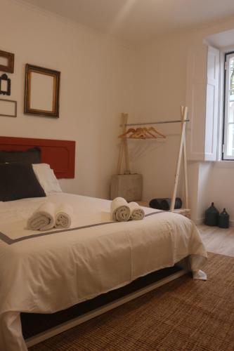 a bedroom with a bed with two towels on it at Nooks Sintra three in Sintra