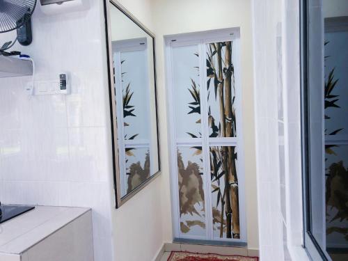 a bathroom with two mirrors on the wall at Homestay Farah Wangsa Maju KL in Kuala Lumpur