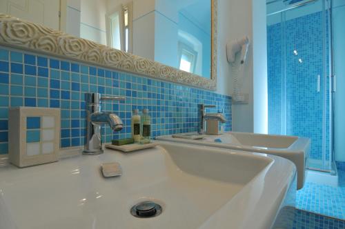 a bathroom with a sink and a mirror at B&B Il Grifone in Pistoia