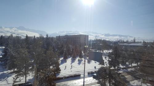 a view of a city with snow and mountains at Apartment in the Karakol heart in Karakol
