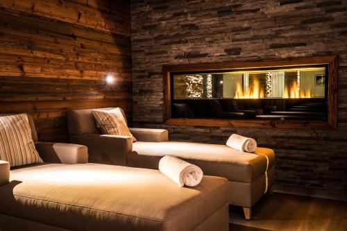a living room with two chairs and a fireplace at The Capra Saas-Fee in Saas-Fee