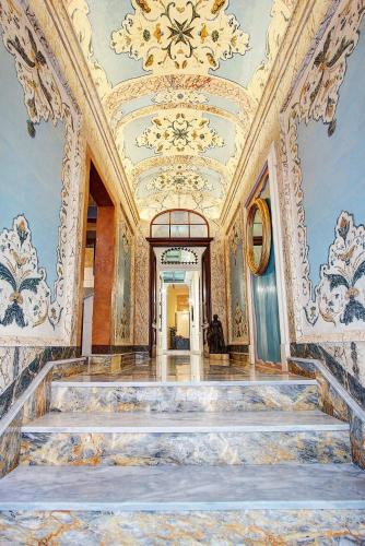 a hallway with a staircase in a building with a ceiling at Palazzo Paolina Boutique Hotel in Valletta