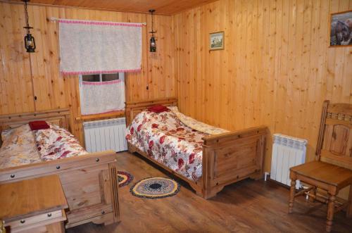 a bedroom with two beds and a desk and a chair at Guest House Kupechesky in Uglich