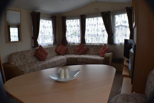 a living room with a table and a couch at The Pearl in Bude