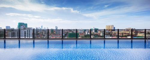 a view of a city skyline from a swimming pool at One Residence Hotel & Apartment in Phnom Penh
