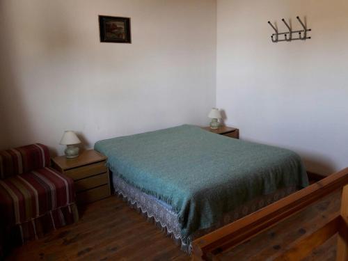 a bedroom with a bed and a couch in it at Amaneceres Las Grutas in Las Grutas