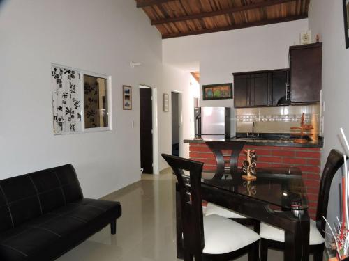 a living room with a table and a couch and a piano at APARTAMENTO SAN GIl in San Gil