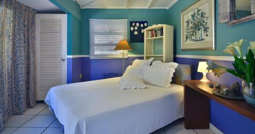 Ένα ή περισσότερα κρεβάτια σε δωμάτιο στο Beach House Aruba Apartments