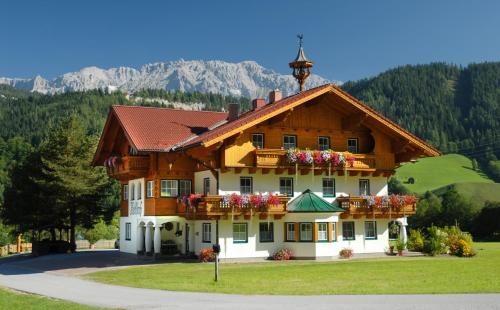 a large building with flowers on the front at Heisshof in Schladming