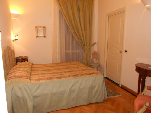 a hotel room with a bed in a room at Al Teatro in Livorno