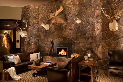 a living room with a stone wall with a fireplace at The Lakefront Anchorage in Anchorage