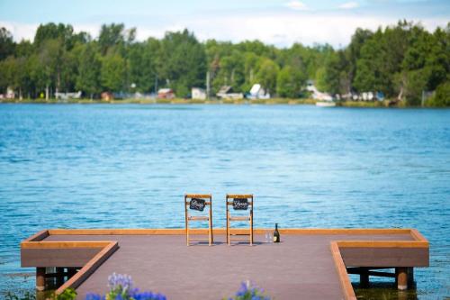 two chairs sitting on a dock on a lake at The Lakefront Anchorage in Anchorage