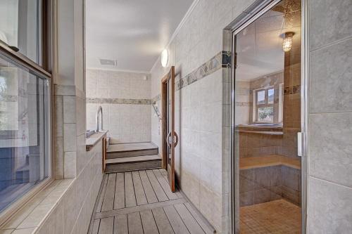 a bathroom with a walk in shower next to a toilet at River Mountain Lodge by Breckenridge Hospitality in Breckenridge