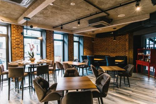 a restaurant with tables and chairs and brick walls at Noble Boutique Hotel in Lutsk