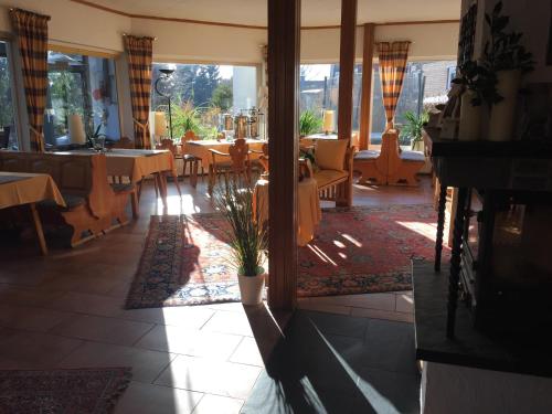 a restaurant with tables and chairs in a room at Hotel Carlsruh in Braunlage
