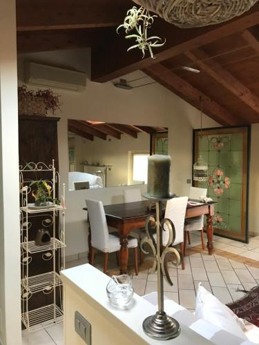 a kitchen with a table and chairs and a dining room at B&B Lodi Centro in Lodi