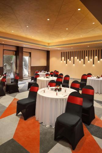 a conference room with tables and chairs in it at Kabir Hotel & Spa in Vadodara