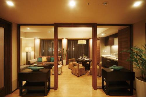 a living room with a couch and a table at Moon Ocean Ginowan Hotel & Residence in Ginowan