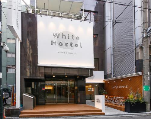 a building with a sign for a white museum at White Hostel Shinsaibashi in Osaka