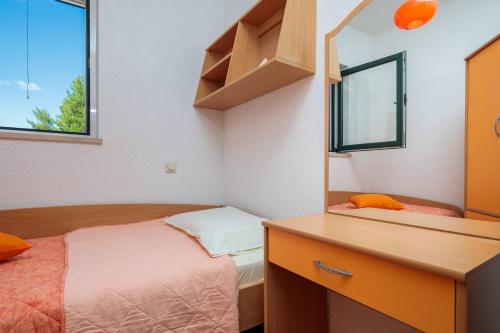 a bedroom with a bed and a dresser and a mirror at Luxury Residence Omis in Omiš
