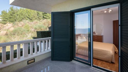a room with a balcony with a bed and a view at Luxury Residence Omis in Omiš