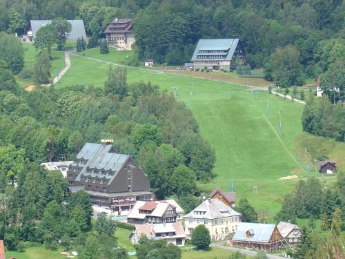 an aerial view of a town with houses and a field at Penzion Roko in Rokytnice nad Jizerou