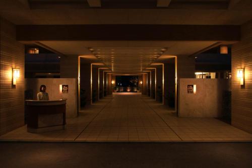 an empty hallway in a building with lights on at Moon Ocean Ginowan Hotel & Residence in Ginowan