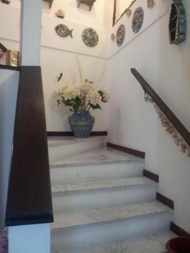 a stairway with a vase with flowers in it at Affittacamere Rosa Dei Venti in Levanto
