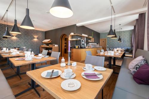 a dining room with wooden tables and chairs at Torstuben in Tettnang