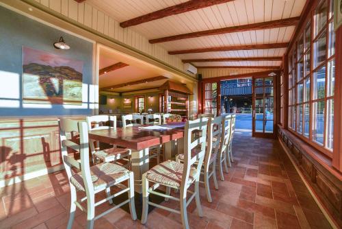 a dining room with a table and chairs at Villa Les with Hot tub & Sauna in Brežice