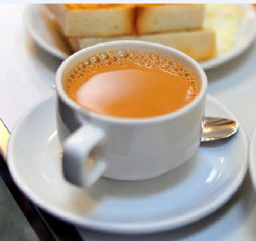 een kop koffie op een wit bord met brood bij Resort Like No Other in Uggalboda